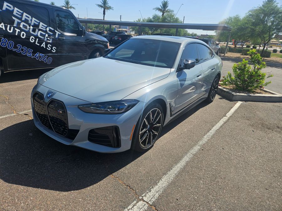 BMW i4 M50 parked beside the Perfect Touch van for a windshield appointment