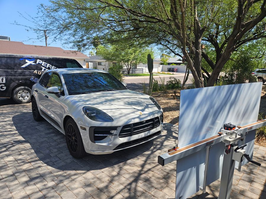 Porsche Macan GTS in a driveway with the windshield setting stand ready