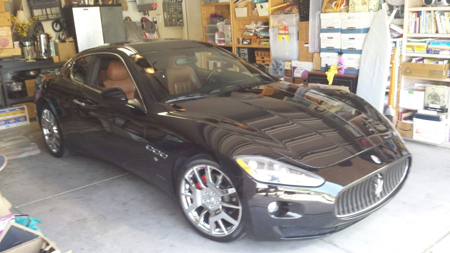 Black Maserati GranTurismo parked in the customer's home garage