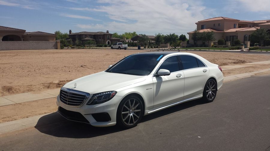 White Mercedes S63 AMG with retention tape still on a freshly installed windshield
